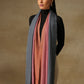 Model is wearing Pashmina Ombre stole in self weave in gray, blush pink & orange colours. 