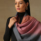 Model is wearing Pashmina Ombre stole in self weave in gray, blush pink & orange colours. 