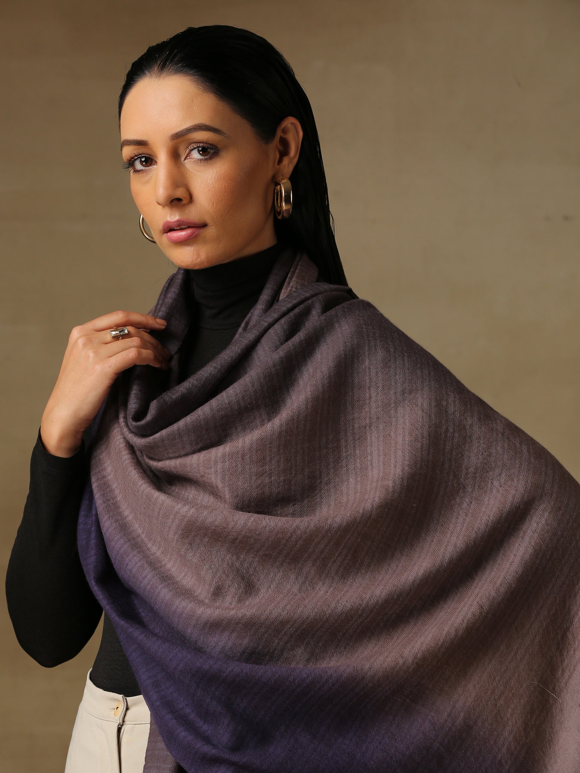 Model is wearing pashmina ombre in self weave stole in cedar colours of gray and violet. 