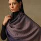 Model is wearing pashmina ombre in self weave stole in cedar colours of gray and violet. 