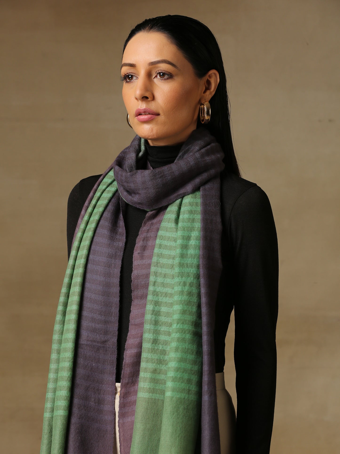 Model is wearing a Pashmina Ombre stole in Self weave in the colours twilight green.