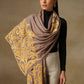 Model is wearing a Velvet Affair stole from shaza featuring a yellow velvet applique on a toosh coloured cashmere stole. 