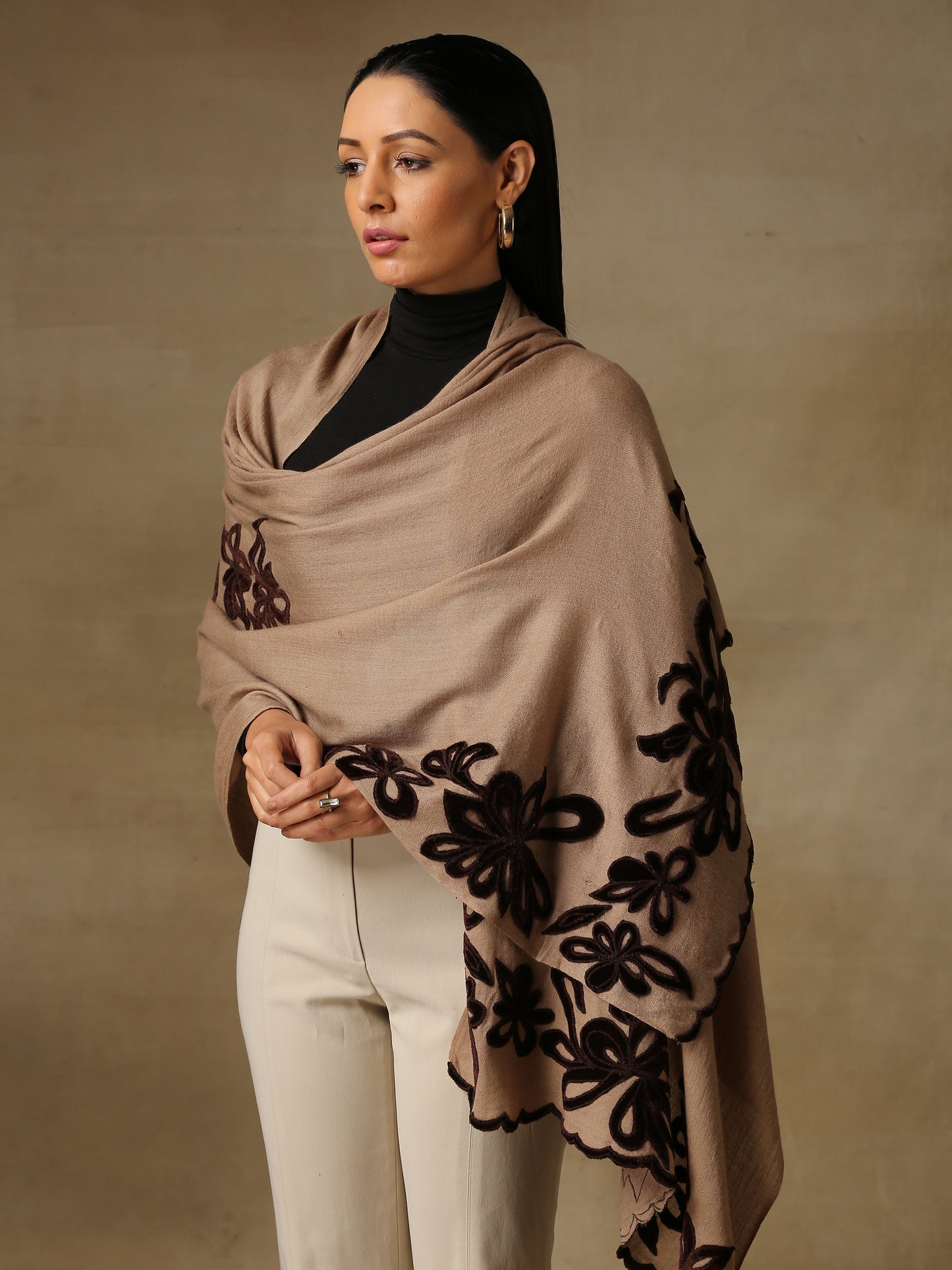 Model is wearing a Velvet Affair stole from Shaza featuring brown velvet applique on a toosh coloured cashmere stole. 