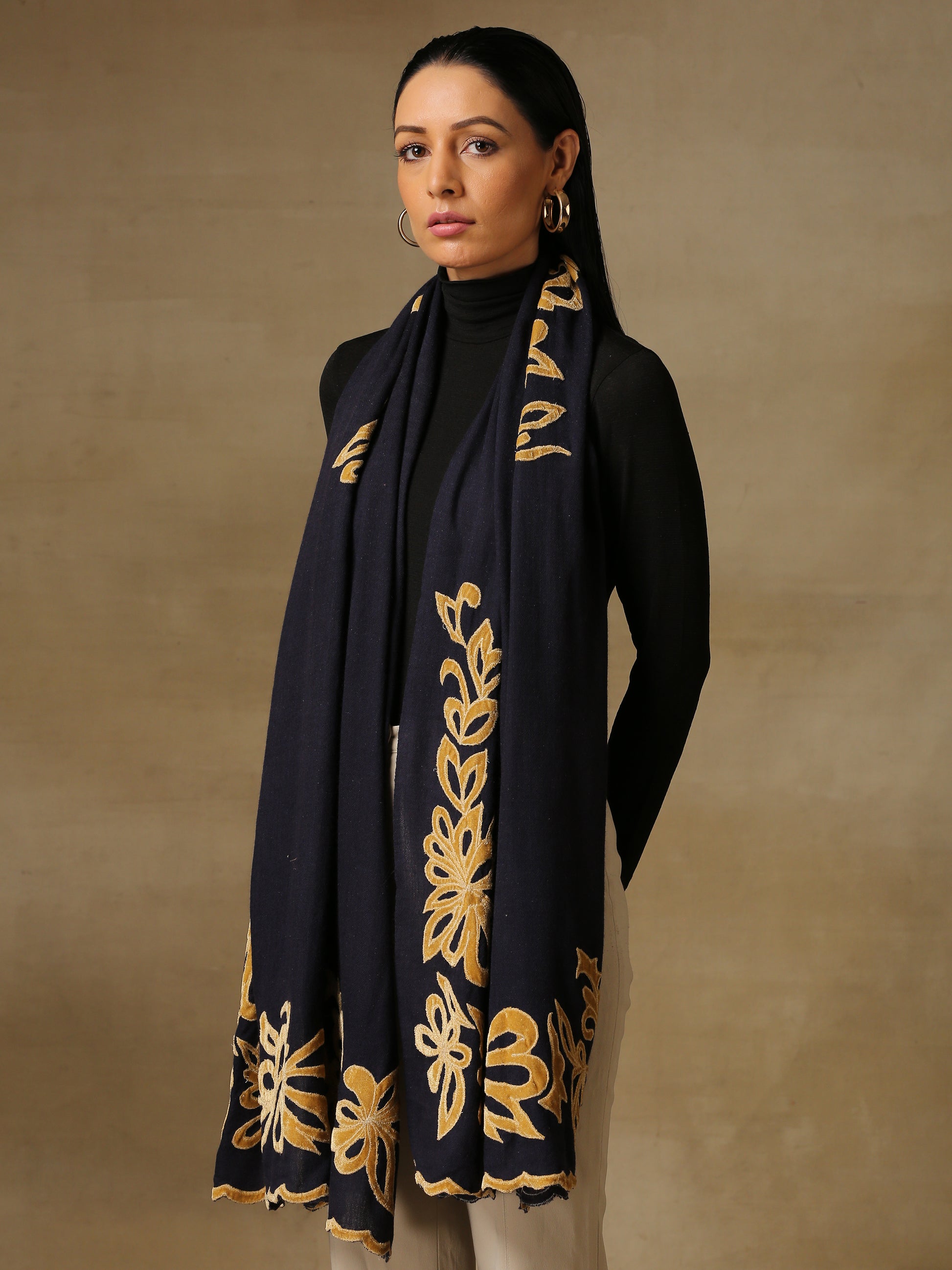 Model is wearing a Velvet Affair stole from Shaza featuring yellow velvet applique on a midnight blue coloured cashmere stole. 