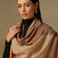 Model is wearing a Pardah stole by Shaza in orange and natural.
