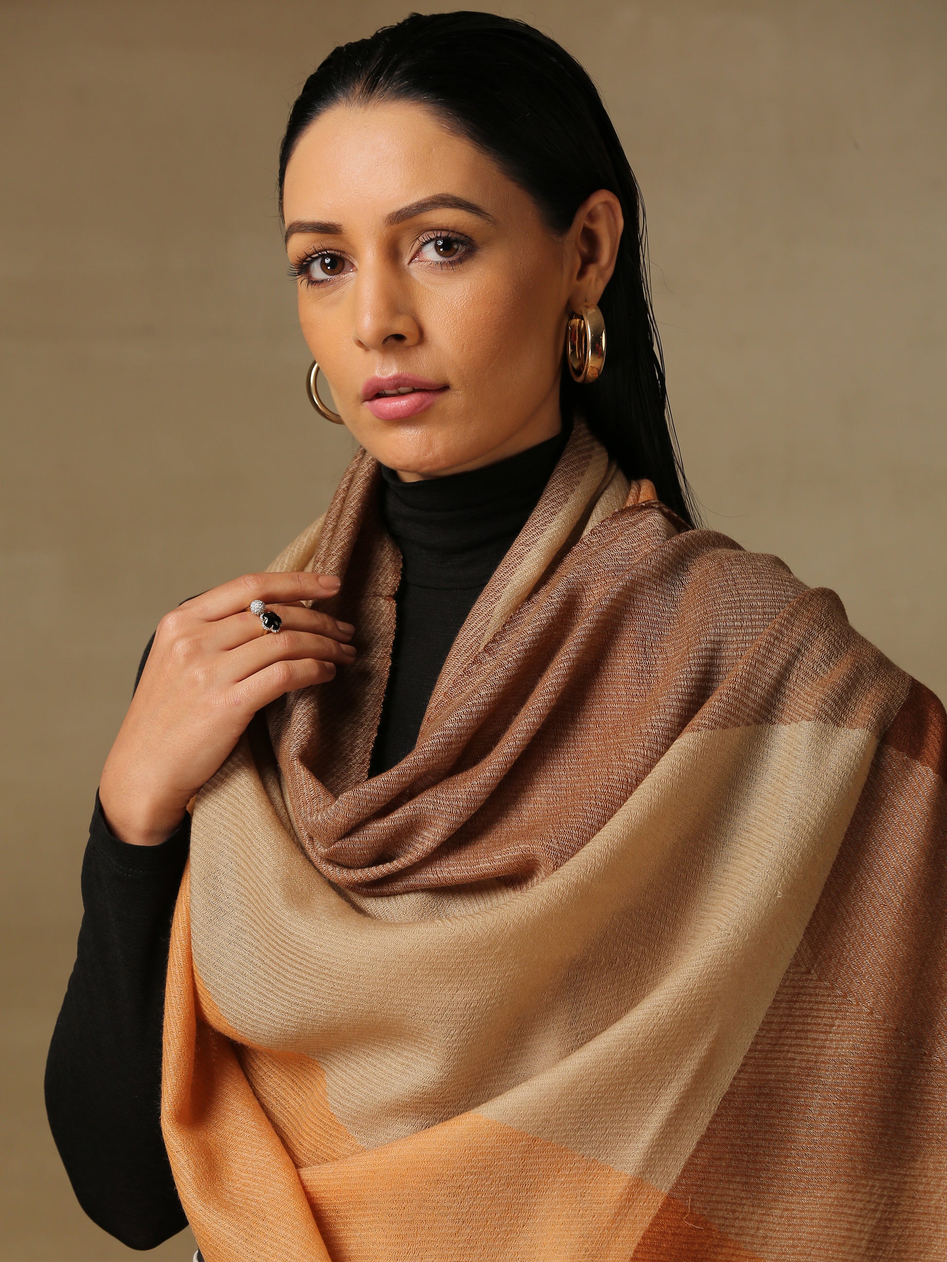 Model is wearing a Pardah stole by Shaza in orange and natural.