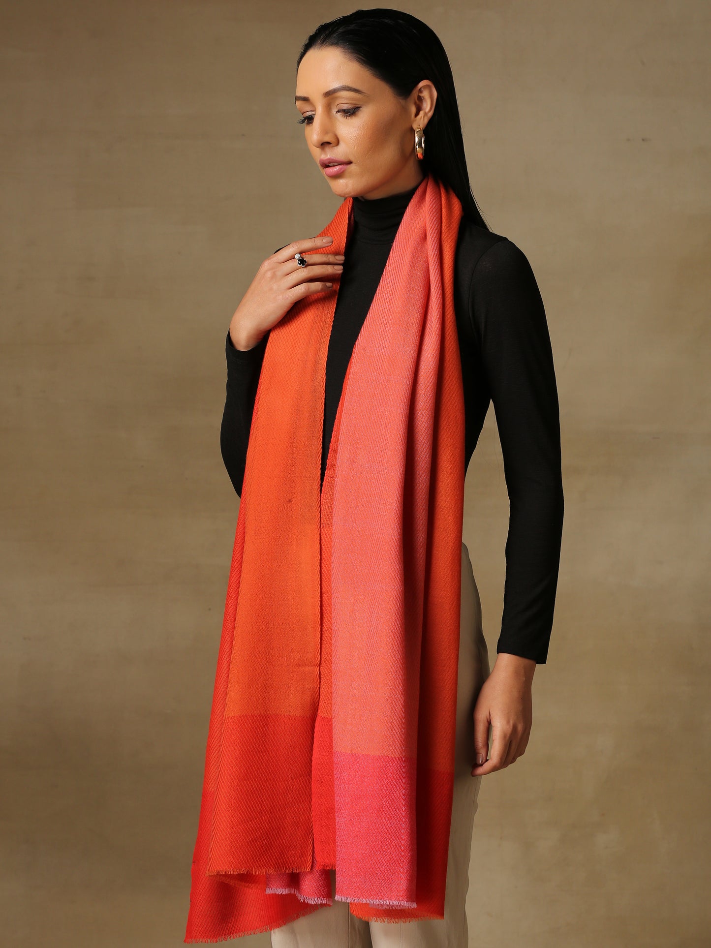 Model is wearing a Pardah stole by Shaza in vermillion orange.