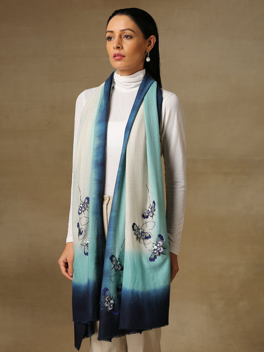 Model is wearing a Beetle pashmina stole from Shaza in the colour Ocean, featuring threadwork beetle shapes uplifted with hand embroidered pearls, sequins and swarovski..