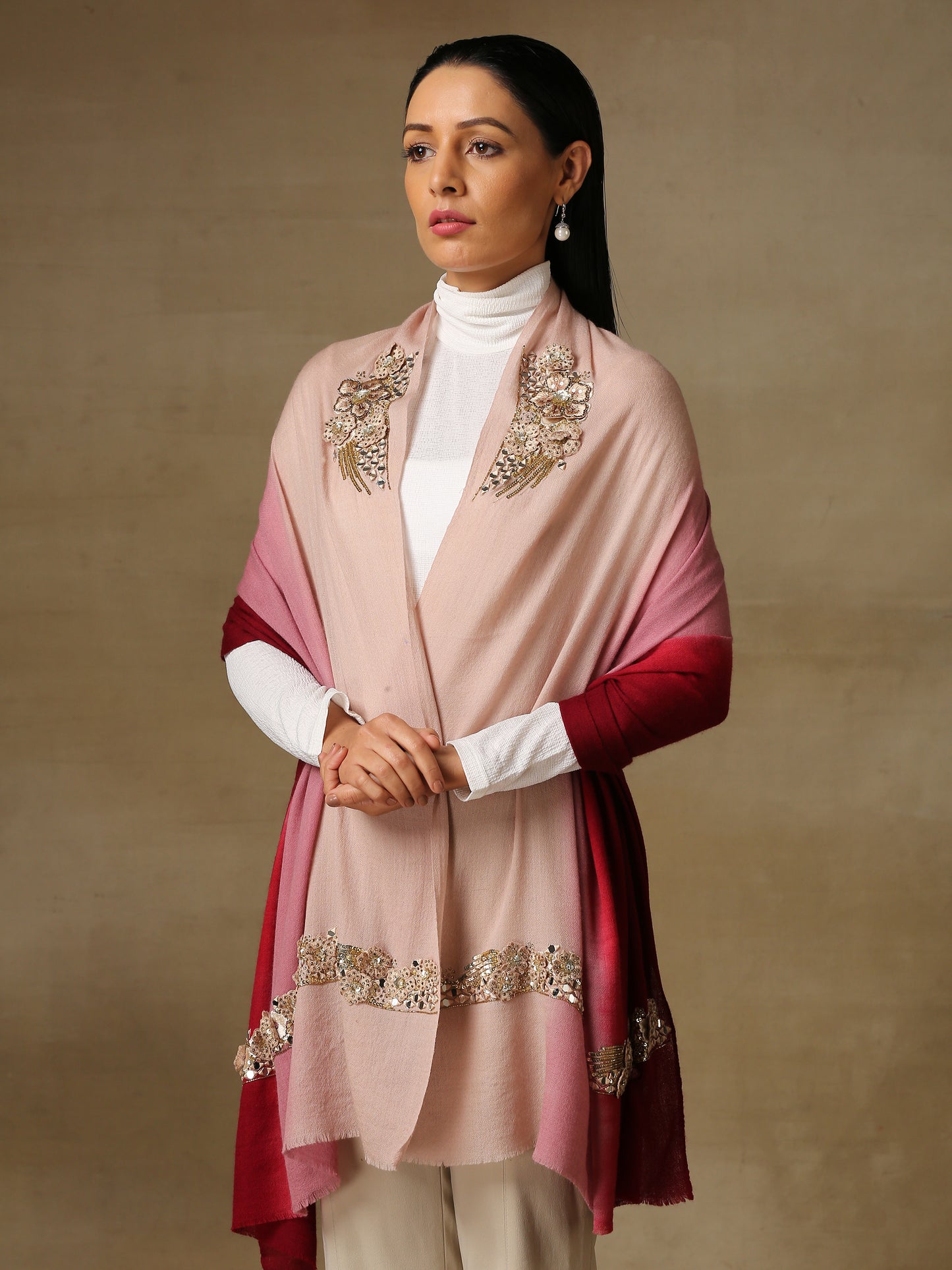 Model is wearing Enchanted pashmina stole from Shaza hand painted in a pink and wine ombre colour, featuring delicate threadwork motifs uplifted with mirrorwork, shellwork, swarovski and cutdana.