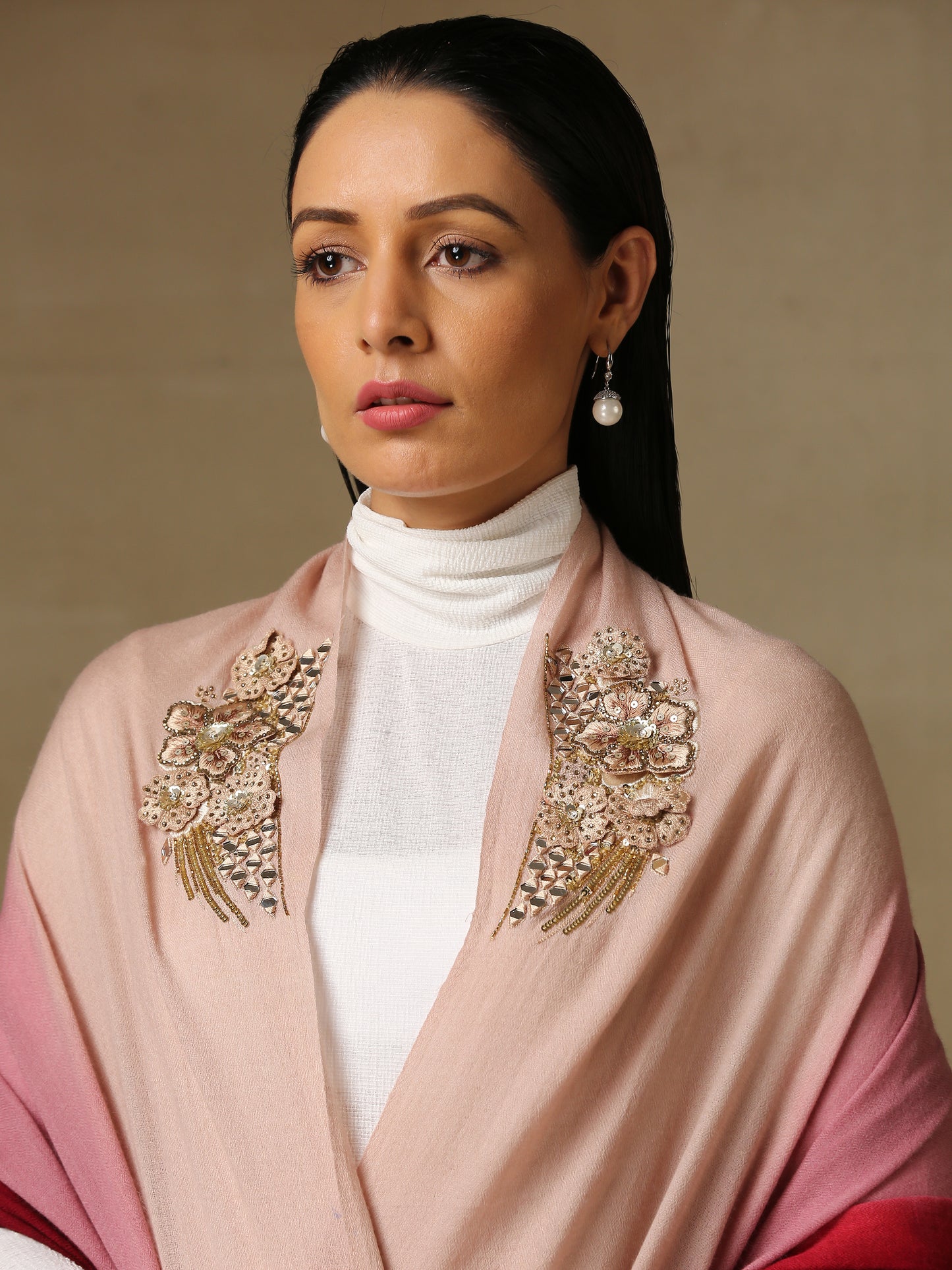 Model is wearing Enchanted pashmina stole from Shaza hand painted in a pink and wine ombre colour, featuring delicate threadwork motifs uplifted with mirrorwork, shellwork, swarovski and cutdana.