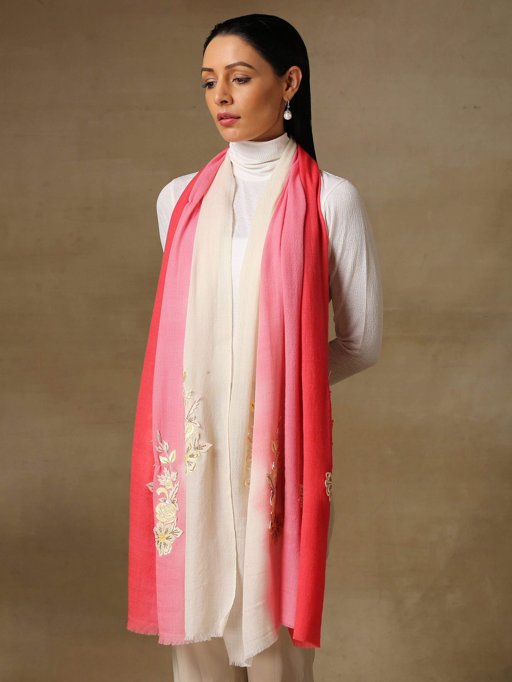 Model is wearing Enchanted pashmina stole from shaza , handpainted in an ombre of fuschia and white colours featuring delicate hand embroidered threadwork motifs uplifted with shellwork and cutdana. 