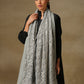 Model is wearing a Celestial Chantilly Zaywar stole from Shaza in seal gray.