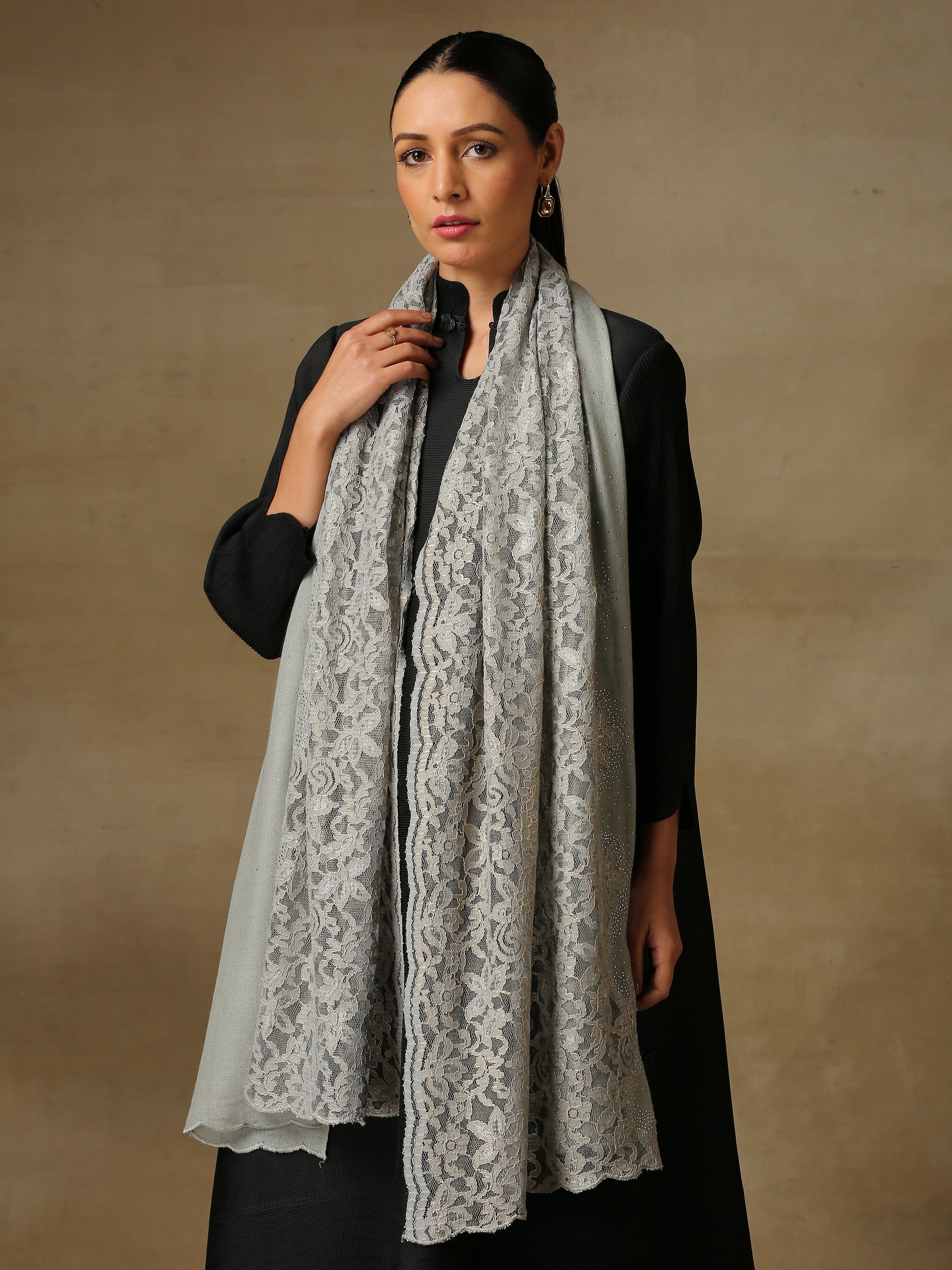 Model is wearing a Celestial Chantilly Zaywar stole from Shaza in seal gray.