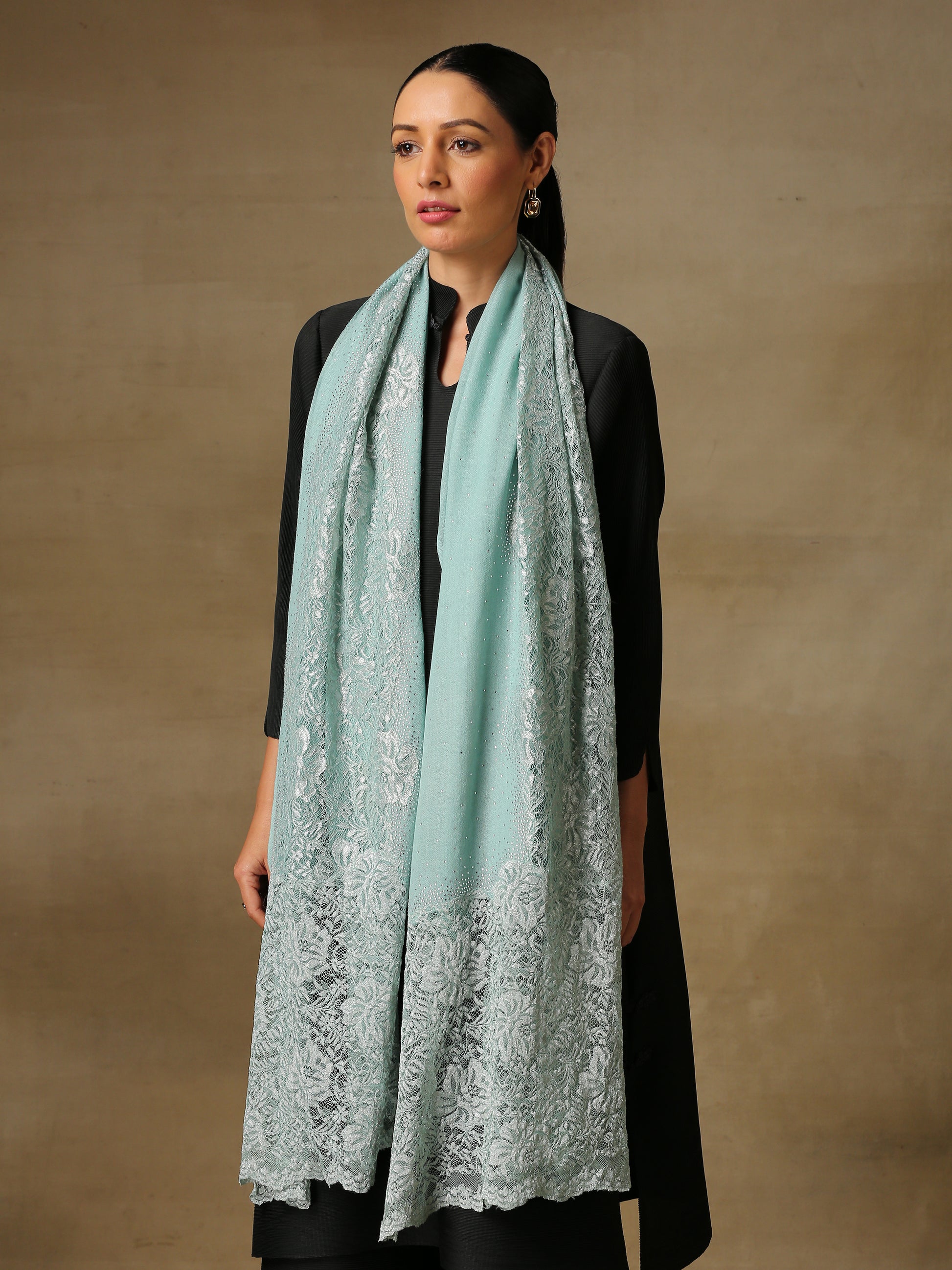 Model is wearing a Celestial Chantilly Zaywar stole from Shaza in sea green.