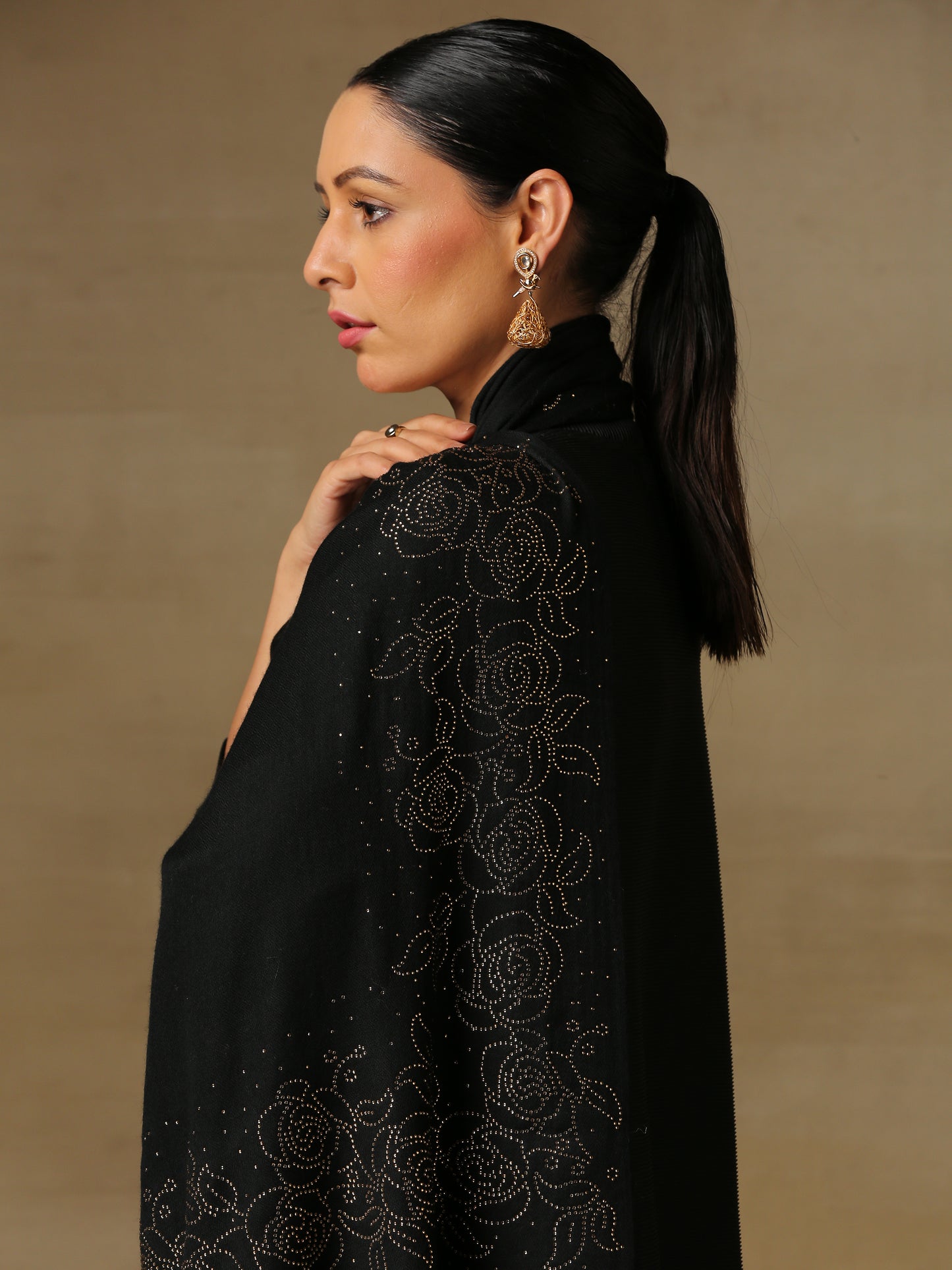 Model is wearing a black stole from the Era of Zaywar Border Swarovski Stole collection, hand embellished with gold swarovski in a roses design