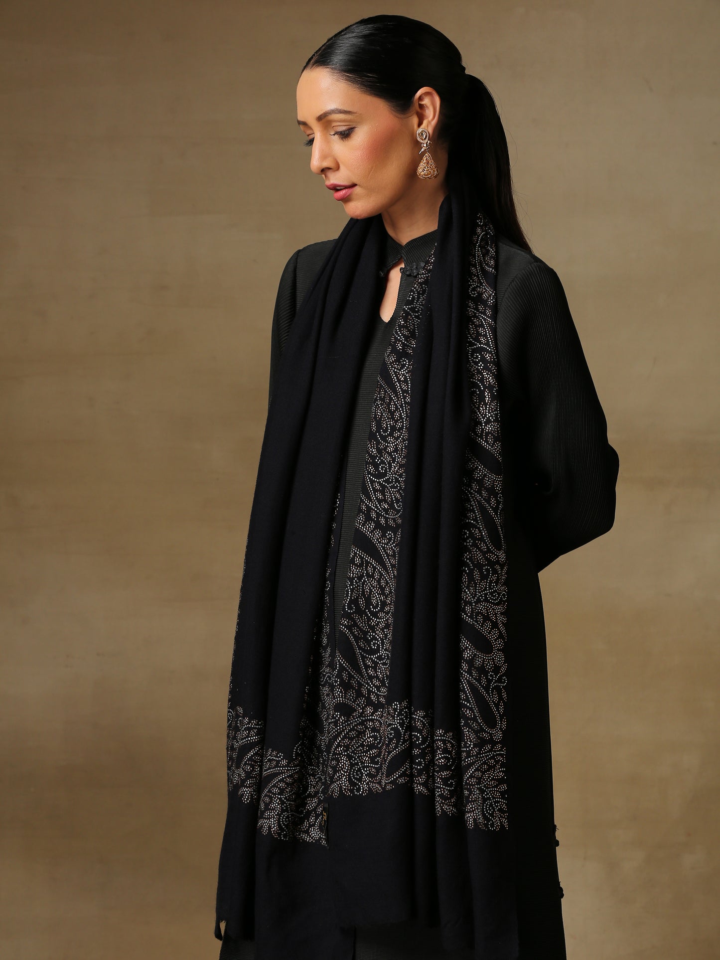Model is wearing black stole from the Era of Zaywar Border Swarovski Stole collection, hand embellished with fine swarovski in paisley design , along the border.