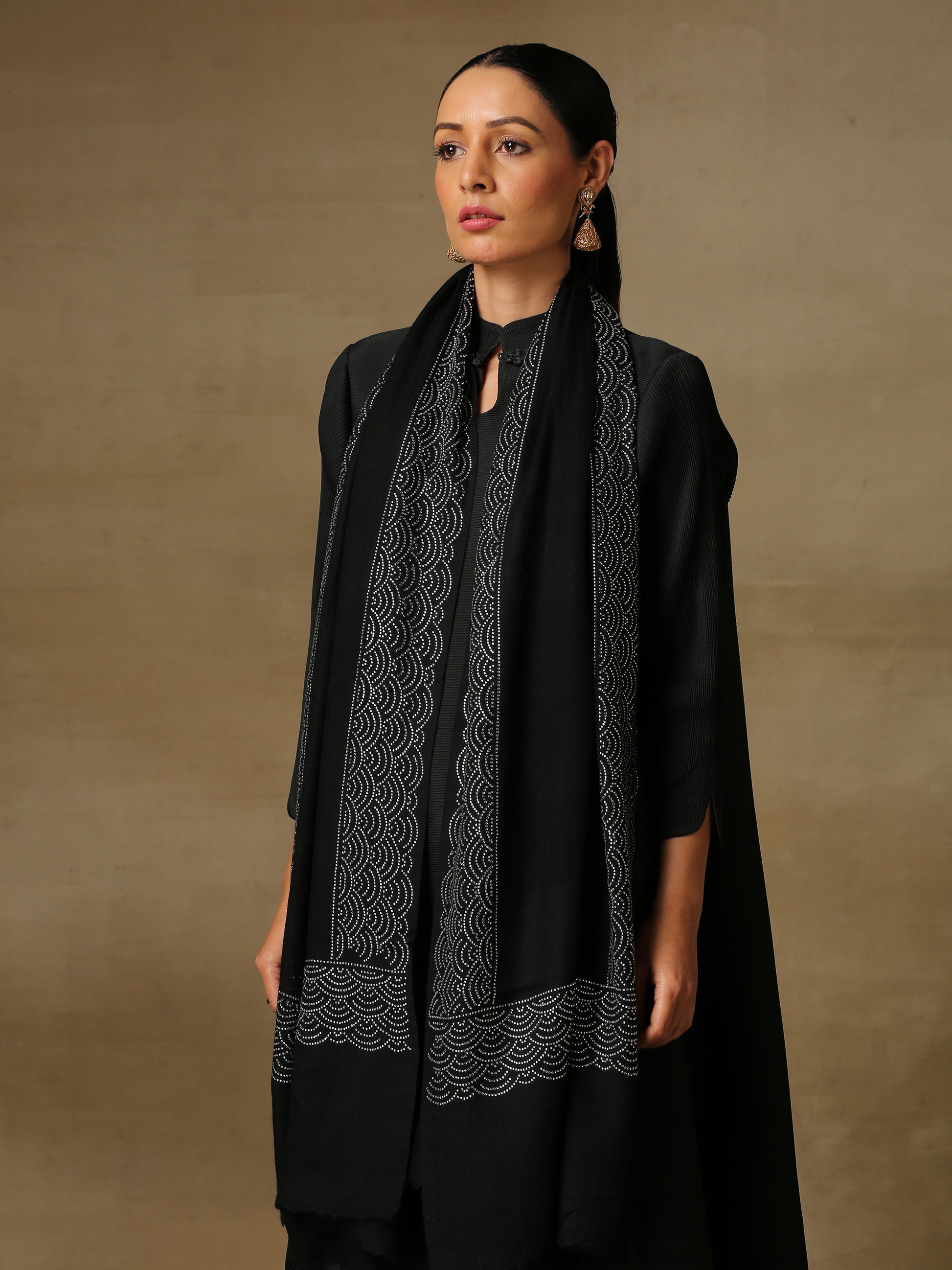 Model is wearing a black stole from the Era of Zaywar Border Swarovski Stole collection, hand embellished with silver swarovski in a clouds design.