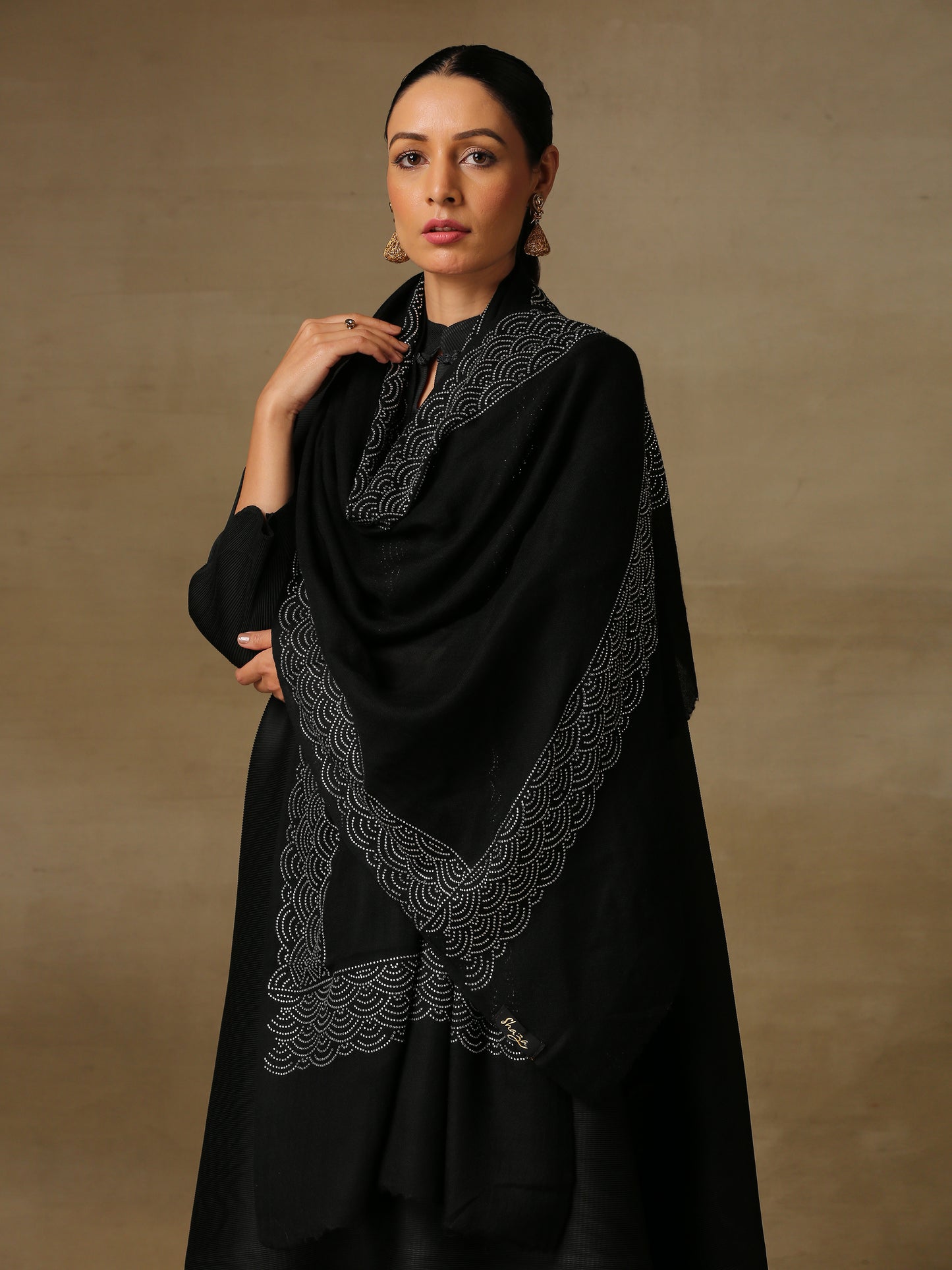 Model is wearing a black stole from the Era of Zaywar Border Swarovski Stole collection, hand embellished with silver swarovski in a clouds design.