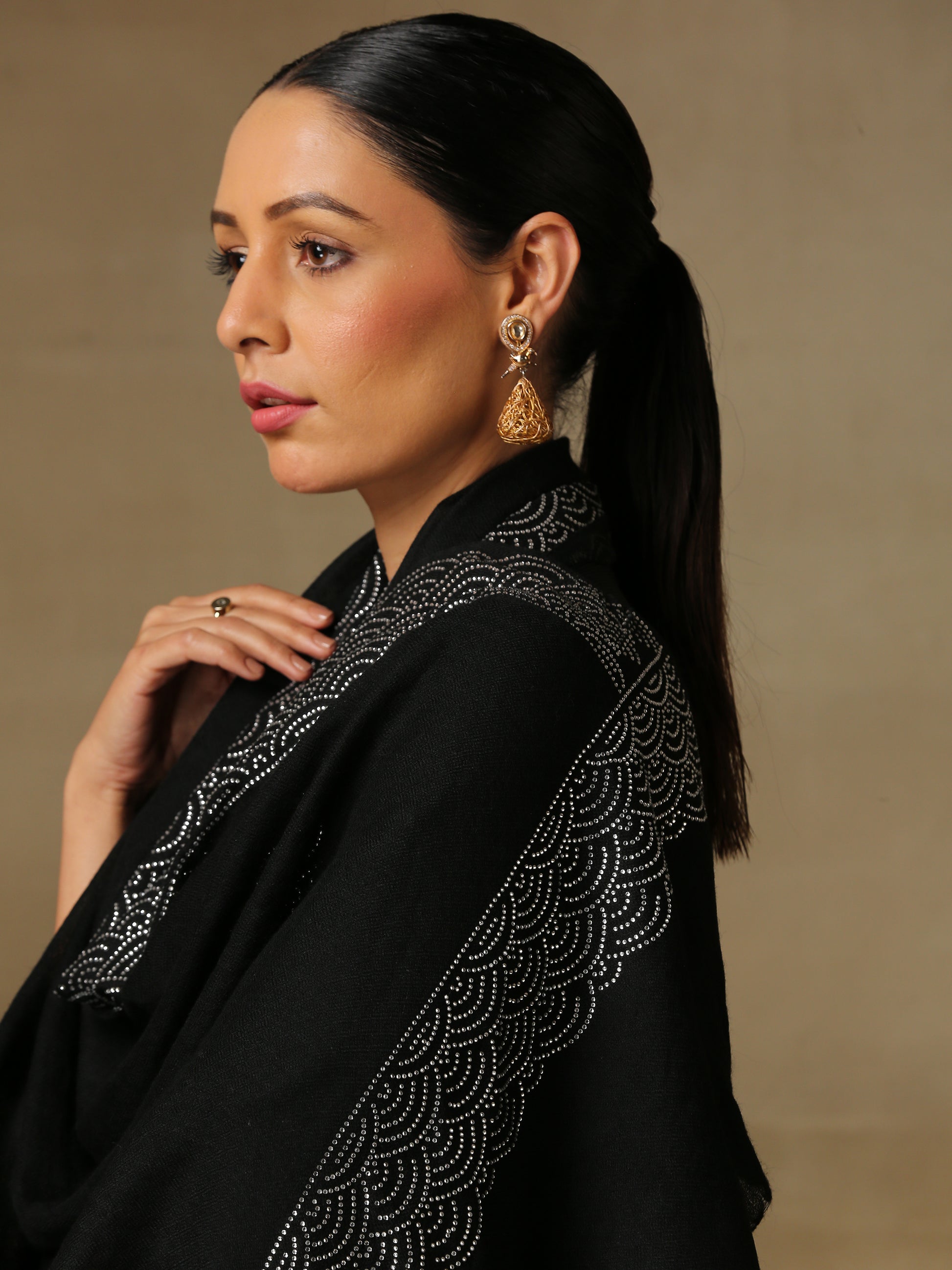 Model is wearing a black stole from the Era of Zaywar Border Swarovski Stole collection, hand embellished with silver swarovski in a clouds design.